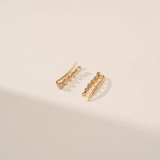Angled view of Curved Slider Diamond Earrings in 14KT Yellow Gold, featuring round lab-grown diamonds along the curved design.