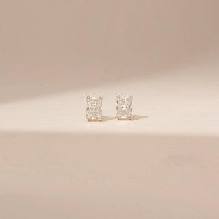Front view of 14KT White Gold diamond earrings with rectangular-cut centre diamonds in four-prong stud settings.