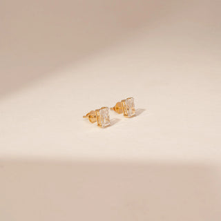 Side view of 14KT White Gold diamond earrings with rectangular-cut centre diamonds in four-prong stud settings.