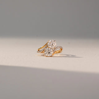 Front view of Dual Round Diamond Ring in 14KT Yellow Gold, featuring two round lab grown diamonds with a pavé crossover band. Set on a beige backdrop, the design highlights layered brilliance and elegance.
