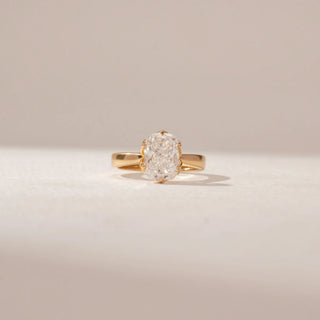 Front view of a 14KT Yellow Gold ring featuring a cushion diamond in a four-prong setting with a polished gold band.