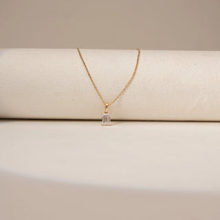 Close-up of Minimal Emerald Cut Diamond Pendant in 14KT Yellow Gold, featuring a single emerald-cut lab-grown diamond.