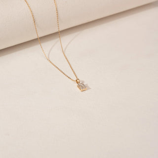 Angled view of Minimal Emerald Cut Diamond Pendant in 14KT Yellow Gold, featuring a single emerald-cut lab-grown diamond.