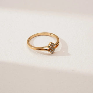 Top angled view of Petite Golden Cluster Diamond Ring in yellow gold, featuring a floral cluster of round lab-grown diamonds held by a split band design, displayed on a soft neutral background.