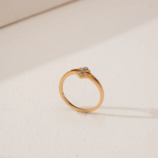 Side angled view of Petite Golden Cluster Diamond Ring in yellow gold, showcasing a floral cluster of round lab-grown diamonds set atop a slender polished band against a neutral backdrop.