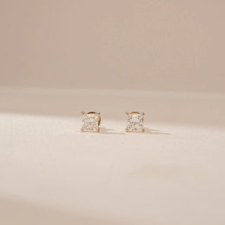 Front view of 14KT Yellow Gold diamond stud earrings, featuring square-cut diamonds in four-prong settings.