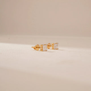 Side view of 14KT Yellow Gold diamond stud earrings, featuring square-cut diamonds in four-prong settings.