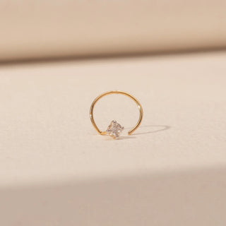 Front view of Round Diamond Nosepin in 14KT Yellow Gold, featuring a round diamond cluster on a delicate open hoop.