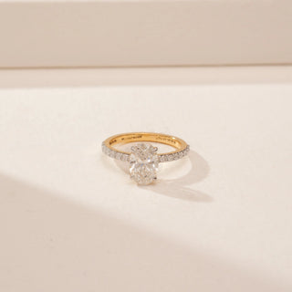 Front view of a 14KT Yellow Gold diamond ring, featuring oval and pear-shaped diamonds with a diamond-set band.