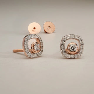 Dual Halo Diamond Stud Earrings in 14KT Rose Gold, shown on a neutral surface, featuring central EF-VVS lab-grown diamonds encircled by double shimmering halos with Bombay screw backs.