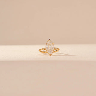Front view of Marquise Solitaire Diamond Ring in 14KT Yellow Gold, featuring a large marquise-cut diamond and pavé band.