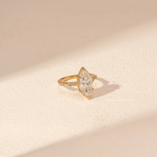 Side view of Marquise Solitaire Diamond Ring in 14KT Yellow Gold, featuring a large marquise-cut diamond and pavé band.
