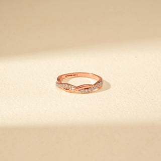 Top view of Intertwined Diamond Ring in 14KT Rose Gold, featuring crossing bands with pavé-set diamonds.