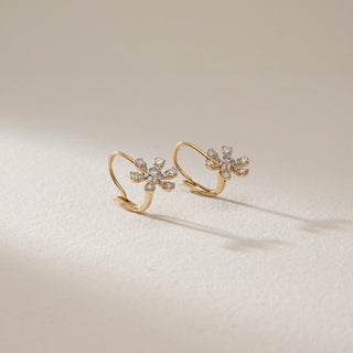 Floral hook diamond earrings in 14KT Yellow Gold, featuring six-petal marquise-inspired clusters set with round lab-grown diamonds, displayed on a soft beige surface with natural light.