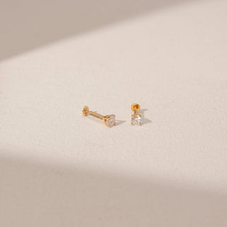 Angled view of Solitaire Diamond Earrings in 14KT Yellow Gold, featuring round lab-grown diamonds in a prong setting.