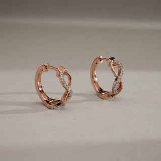 Elegant 14KT Rose Gold hoop earrings with infinity knot design, featuring diamond-studded twists for timeless sparkle.