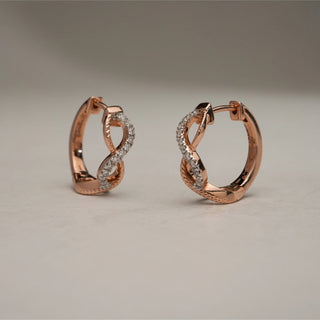 Elegant 14KT Rose Gold infinity knot hoop earrings with diamond-studded arcs, symbolising timeless connection and elegance.