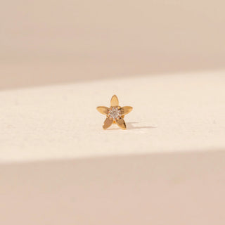 Front view of a 14KT yellow gold floral diamond nosepin, featuring a round lab-grown diamond at the centre of five petals.