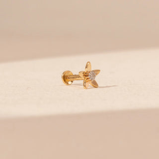 Side view of a 14KT yellow gold floral diamond nosepin, featuring five petals and a centred round lab-grown diamond.