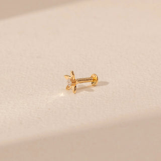 Angled view of a 14KT yellow gold floral diamond nosepin, featuring five petals and a centred round lab-grown diamond.