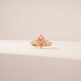 Close-up view of a 14KT Yellow Gold diamond ring featuring a marquise-cut pink centre diamond.