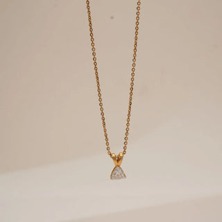 Front view of minimalist trillion-cut lab-grown diamond pendant necklace in yellow gold, featuring a triangular solitaire diamond suspended from a delicate fine gold chain.