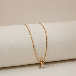 Angled view of minimalist trillion-cut lab-grown diamond pendant necklace in yellow gold, featuring a triangular solitaire diamond suspended from a delicate fine gold chain.