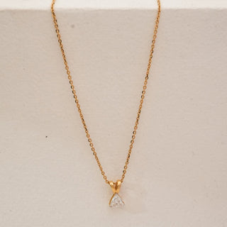 Front view of minimalist trillion-cut lab-grown diamond pendant necklace in yellow gold, featuring a triangular solitaire diamond suspended from a fine delicate chain.