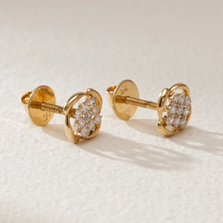 Pair of Vintage Lattice Diamond Stud Earrings in 14KT Yellow Gold with a floral-inspired cluster of round-cut diamonds, secured with Bombay screw backs, displayed on a light textured surface.