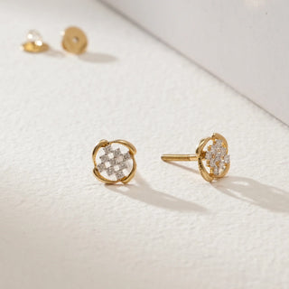 Pair of Vintage Lattice Diamond Stud Earrings in 14KT Yellow Gold with intricate interwoven lattice design and round-cut diamonds, displayed on a light surface with Bombay screw backs visible in the background.