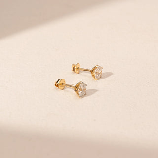 Side view of Round Diamond Stud Earrings in 14KT Yellow Gold, featuring round lab-grown diamonds in prong settings.