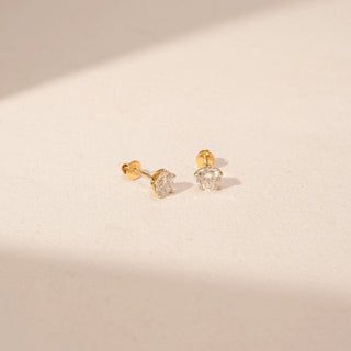 Angled view of Round Diamond Stud Earrings in 14KT Yellow Gold, featuring round lab-grown diamonds in prong settings.