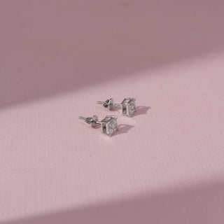 Angled  view of Princess Diamond Stud Earrings in 14KT White Gold, featuring square lab-grown diamonds in sleek settings.