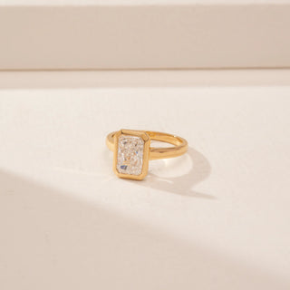 Side view of a 14KT Yellow Gold diamond ring, featuring a rectangular step-cut centre diamond in a bezel setting.