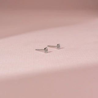 Side view of a 14KT White Gold diamond earrings with pear-shaped diamonds in secure stud settings.