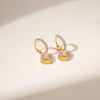 Top view of 14KT Yellow Gold diamond drop earrings with emerald-cut centre stones, pavé halos and diamond-set huggie hoops.