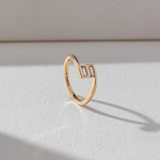 Side view of Baguette Diamond Open Ring in 14KT Yellow Gold, featuring two baguette-cut lab grown diamonds in bezel settings on an open band. Set on a beige backdrop, the design highlights structure and modern elegance.
