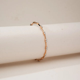Side view of Rose Gold Duo Diamond Bangle, featuring paired round lab-grown diamonds set along a slender rose gold rail, gracefully draped over a soft neutral display form.