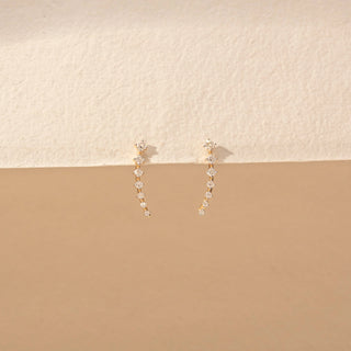 Front view of Curved Drop Diamond Earrings in 14KT Yellow Gold, featuring round diamonds in a graceful cascading design.