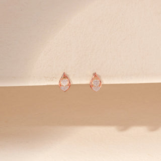 Front view of Teardrop Diamond Stud Earrings in 14KT Rose Gold, featuring round diamonds framed by a delicate teardrop silhouette.