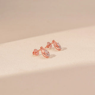 Side view of Teardrop Diamond Stud Earrings in 14KT Rose Gold, featuring round diamonds framed by a delicate teardrop silhouette.