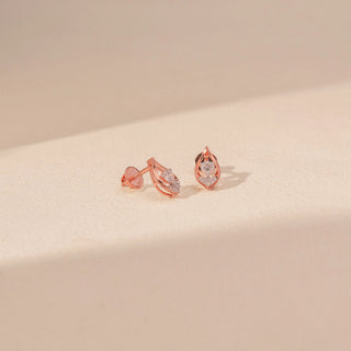 Angled view of Teardrop Diamond Stud Earrings in 14KT Rose Gold, featuring round diamonds framed by a delicate teardrop silhouette.