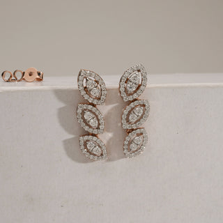 Front view of Triple Marquise Diamond Drop Earrings in rose gold with a push-pull mechanism. Each earring displays three vertically aligned marquise diamond clusters, set in pavé halos, crafted with EF colour, VVS clarity diamonds. Product weighs 4.12 grams with 1.21 carats of diamonds, in the INR 50,000–1,00,000 price range.