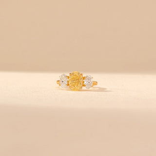 Front view of Oval Yellow Diamond Three-Stone Ring in 14KT Yellow Gold, featuring a yellow oval diamond with oval side stones.