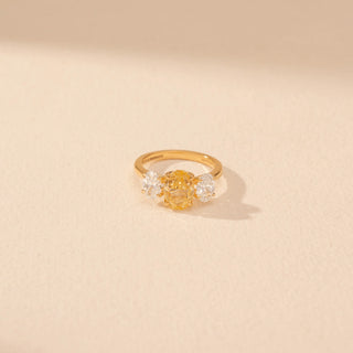 Top view of Oval Yellow Diamond Three-Stone Ring in 14KT Yellow Gold, featuring a yellow oval diamond with oval side stones.