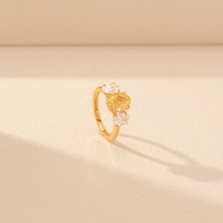 Angled view of Oval Yellow Diamond Three-Stone Ring in 14KT Yellow Gold, featuring a yellow oval diamond with oval side stones.