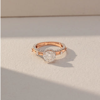 Top view of Round Solitaire Diamond Ring in 14KT Rose Gold, featuring a centred round lab grown diamond with pavé and channel-set accents. Set on a beige backdrop, the design highlights symmetry and refined brilliance.
