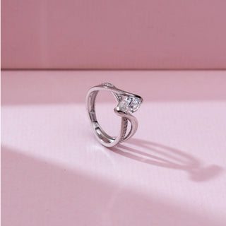 Side angle view of 14KT white gold bypass ring featuring a marquise-cut centre diamond with a flowing split band, one side pavé-set with round diamonds.