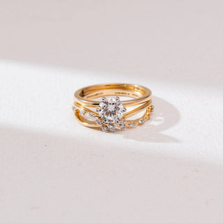 Front view of Radiant Golden Cross Diamond Ring in 14KT Yellow Gold, featuring a round solitaire in a six-prong setting with a pavé diamond cross-over band, set against a soft neutral backdrop.