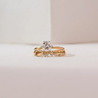 Front view of Radiant Golden Cross Diamond Ring in 14KT Yellow Gold, featuring a round solitaire in a six-prong setting with intersecting pavé diamond bands on a polished gold shank.